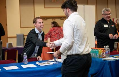 Student at career fair shaking hands