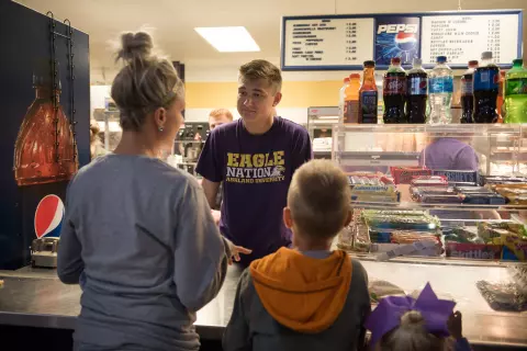 A mother and her son purchase items at Talons Concessions during a game