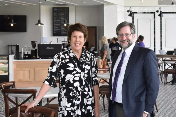 Jody Ruhl and President Jon Peede pose for a photo in the Lyceum Cafe