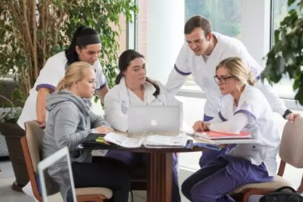 group of nursing students working around table