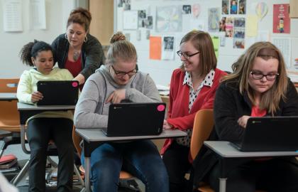 Student teacher in classroom helping students