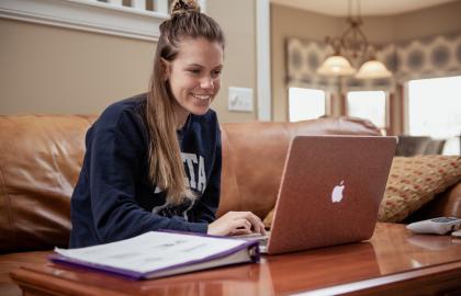 student working on laptop, online class