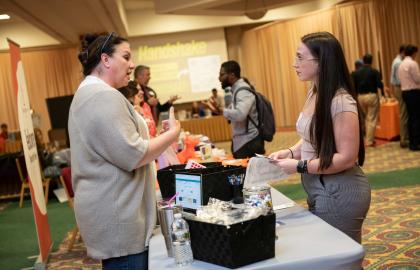 Student at career fair talking with recruiter