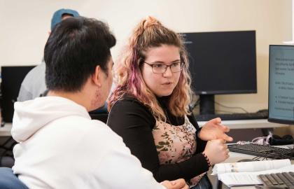 AU Student tutoring another student in the WCC