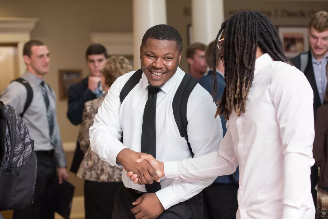 Students shaking hands at COBE Career Day