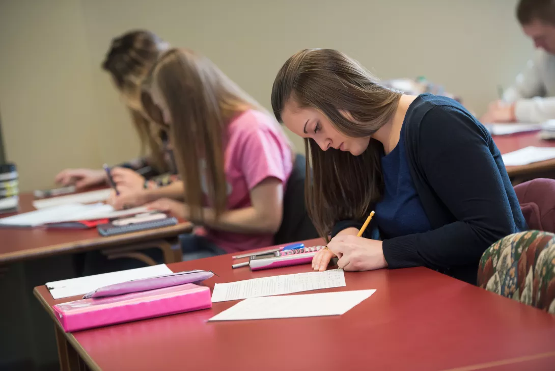 Students in classroom working on paperwork