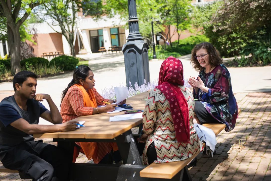 ACCESS student in Advanced Speaking and Listening class sitting outdoors