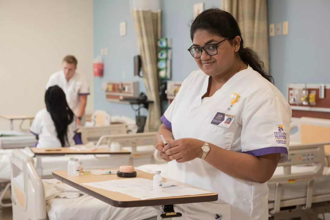 Nursing student prepares syringe tray