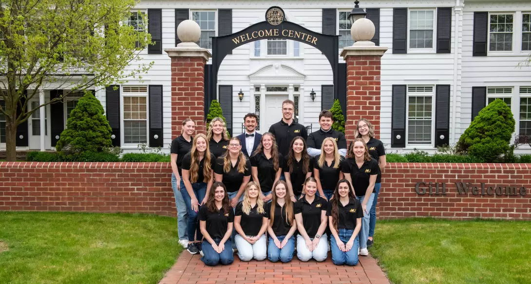 Admissions tour guides in front of Gill Center