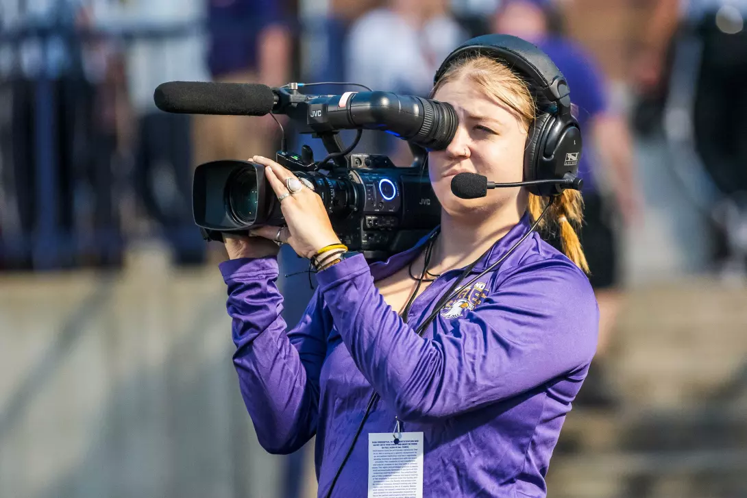 JDM student videoing football game