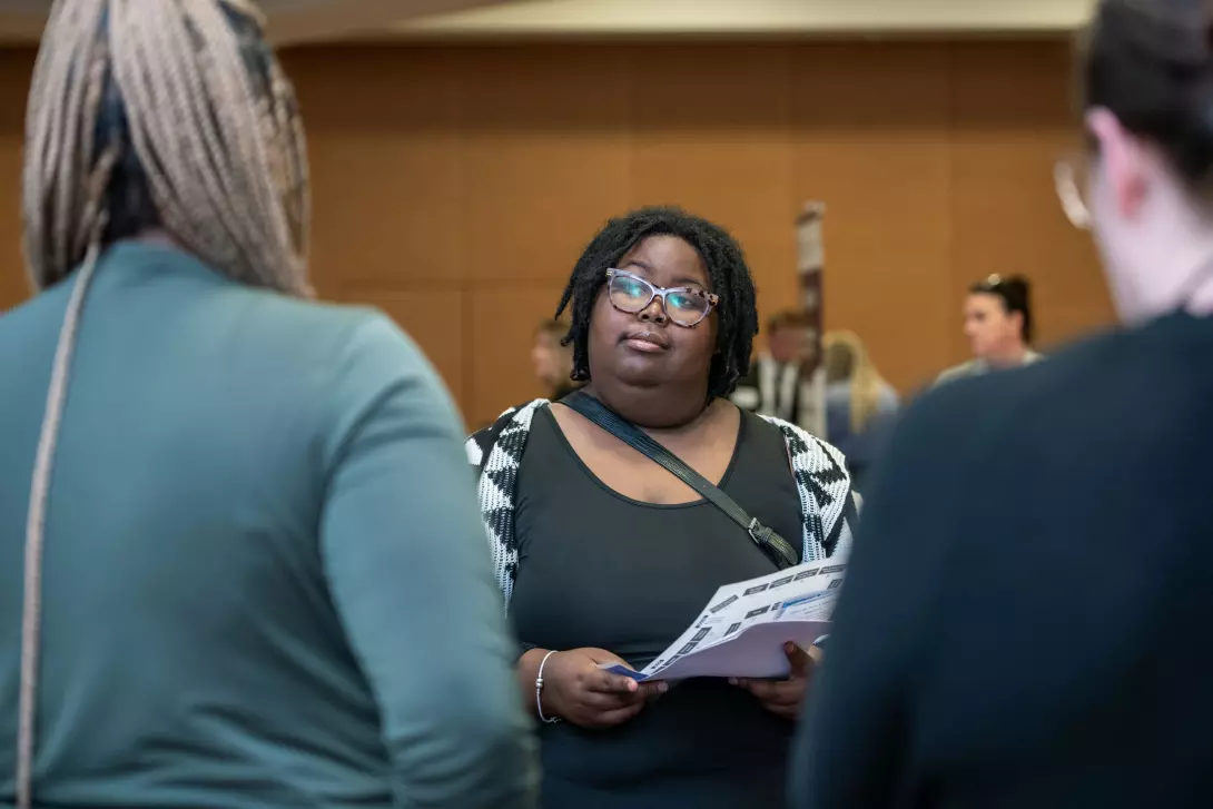 Student talking with recruiter at job fair