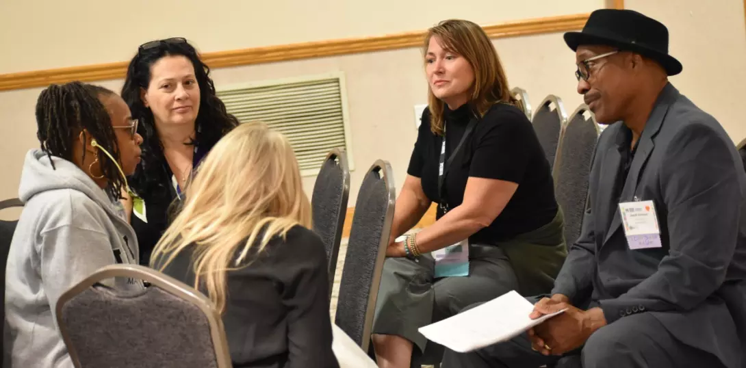 Sharon Shoatz and Sandra Day, bottom left, during a small-group discussion at the Connecting 4 Justice International Conference at Ashland University.